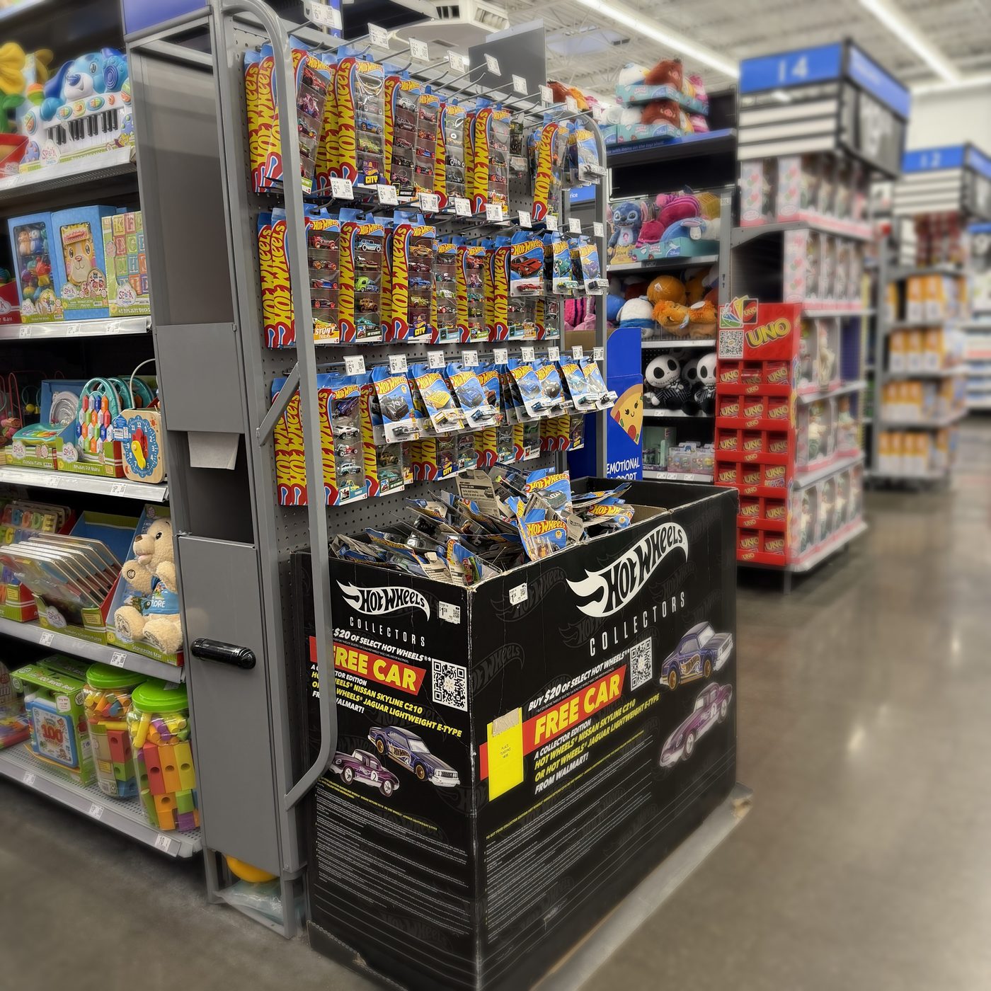 Hot Wheels endcap display and collector dump bin in a retail store
